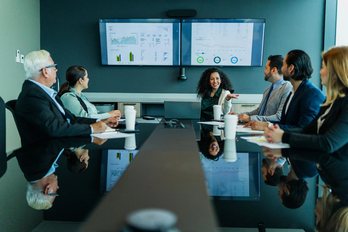 Executives reviewing business performance dashboards together in a boardroom
